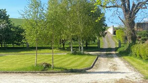 A rural road leading to a building with a stone wall and a grassy area with trees. - Beautiful 5 bedroom home in Mid Ulster- Magherafelt  (County Derry)