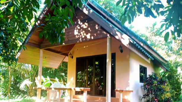 A small, single-story building with a porch and steps leading to a door. - Garden Lodge Bungalow (Klong Son)