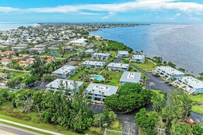 A coastal residential area with houses, a swimming pool, and a view of the ocean.