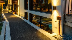 A modern hotel with a wooden facade, multiple balconies, and large windows. - Hotel Tannenhof (Zermatt)