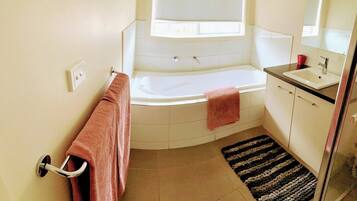 Bathtub, hair dryer, towels, soap