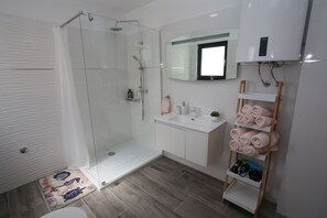 Shower, rainfall showerhead, hair dryer, towels