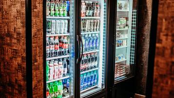 A vending machine area with Coca-Cola Ice Cold and other beverages.