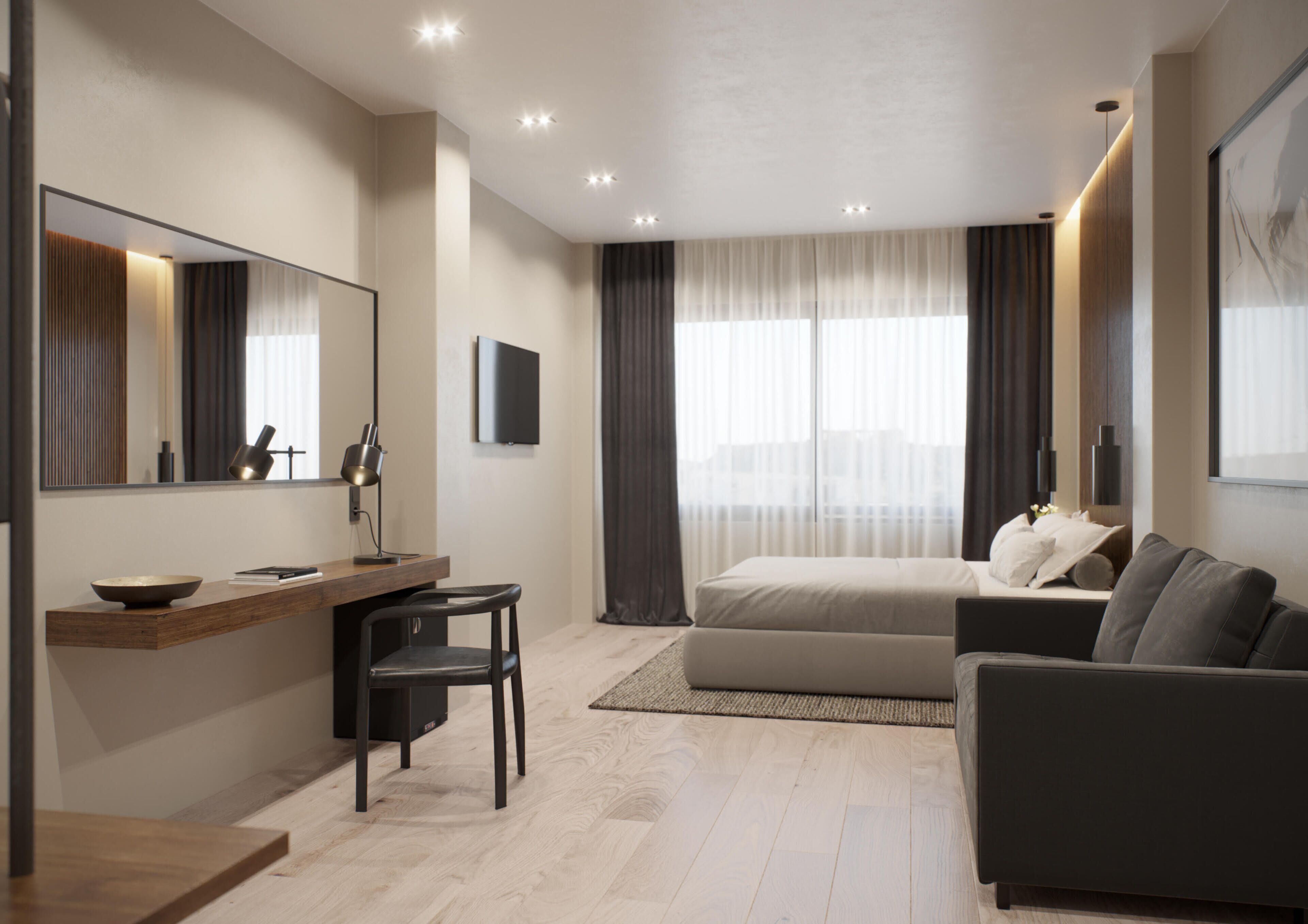 Une chambre d’hôtel moderne équipée d’un lit, d’un canapé, d’un bureau avec une chaise, d’un grand miroir et d’un téléviseur à écran plat.