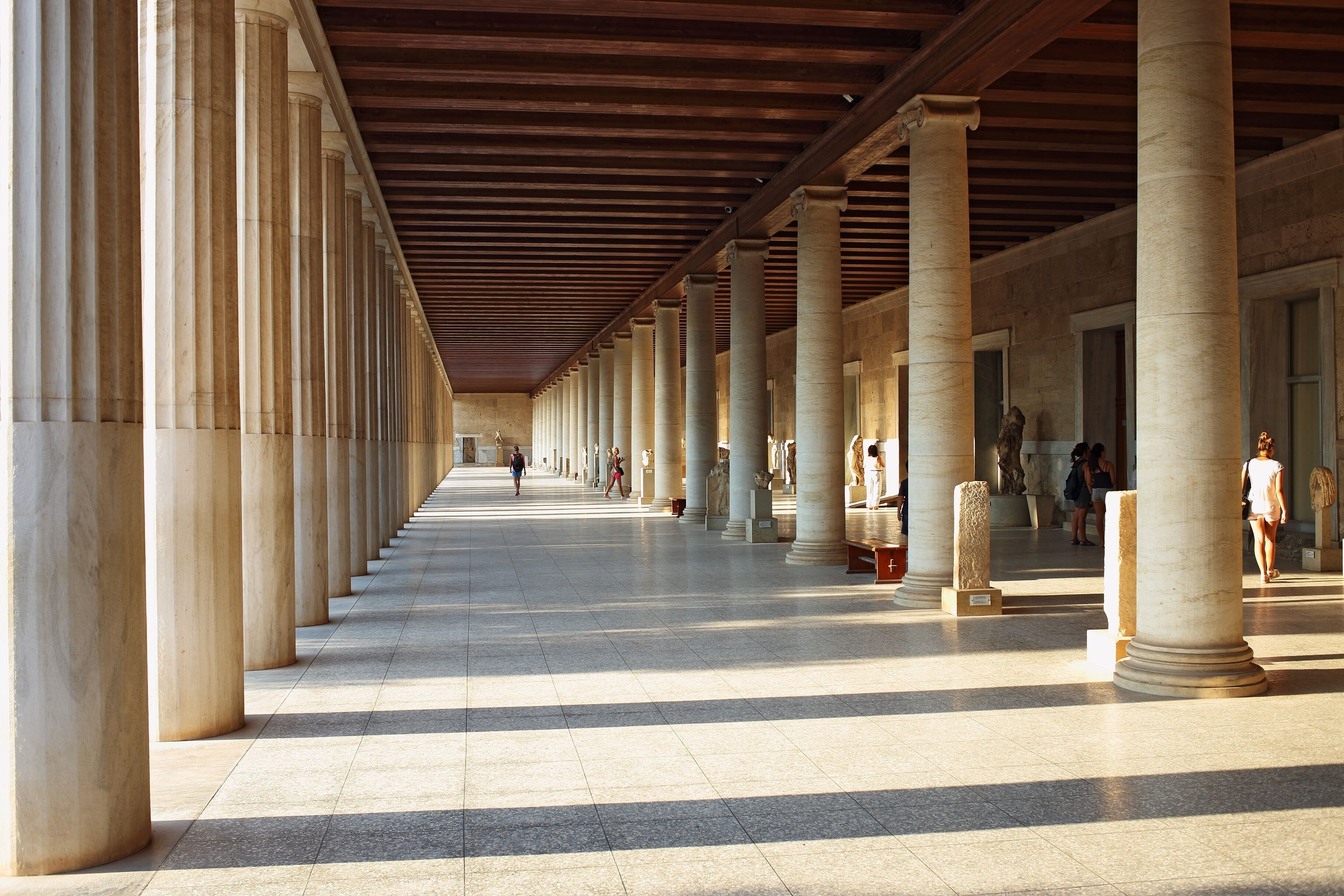 A long corridor with evenly spaced columns and a tiled floor.