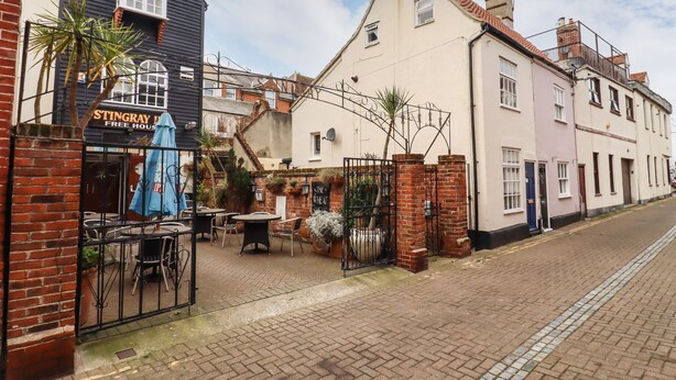 A street view with a pub named "Stingray Free House" and a building with a sign "The Wheat."