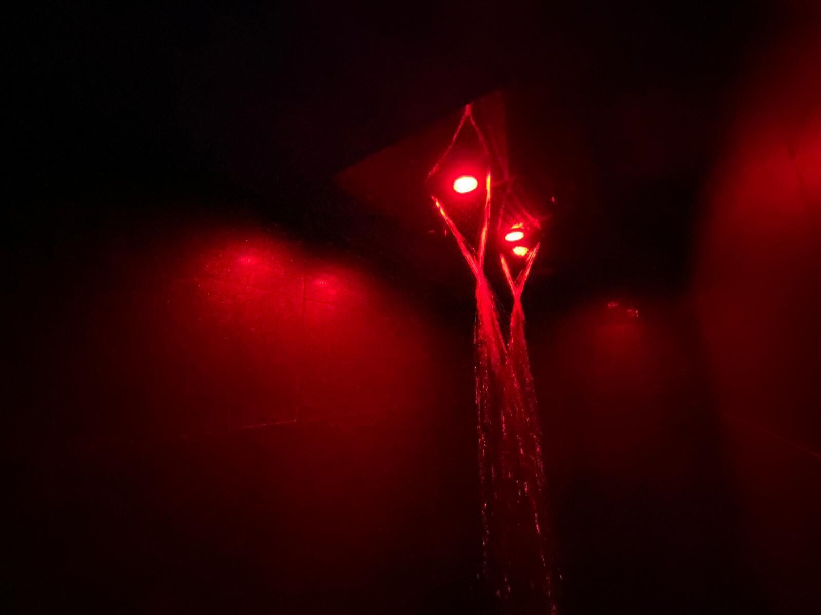 A red traffic light against a dark background.