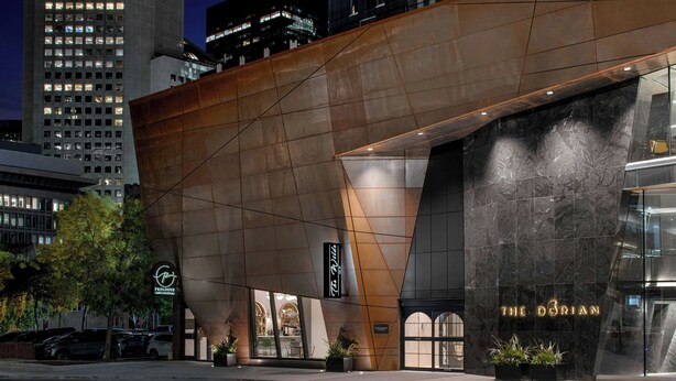 A modern hotel with a prominent entrance and a large sign reading "The Dorian". - The Dorian, Autograph Collection (Calgary)