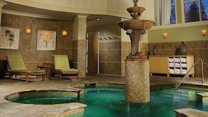 A spa area with a central fountain, lounge chairs, and a tiled floor. - The Cove at Sylvan Beach - Pet friendly lakeside cottage with a pontoon boat! (Sylvan Beach)