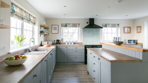 A modern kitchen with a central island, built-in appliances, and ample natural light.