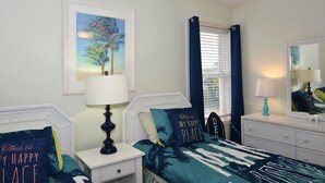 A bedroom with a bed, nightstands, a dresser, a mirror, and a window with curtains.