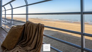 A view from a window with metal bars, labeled "FLOOR 1 SEASIDE," overlooking a beach with sand and water. - Marble Floor, full comfort sea view, parking incl. (Oostende)