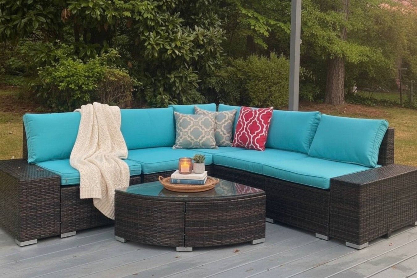 A sectional sofa with a round coffee table in an outdoor setting.