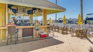 A beachside bar with a counter, chairs, and umbrellas. - Waterfront, Harbourside, Water Park, Beach, #3318 (Indian Rocks Beach)