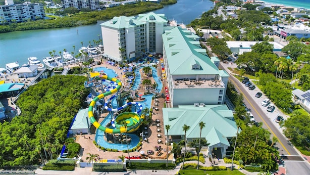 A resort with a large pool area, a water slide, and a view of the ocean. - Waterfront, Harbourside, Water Park, Beach, #3318 (Indian Rocks Beach)