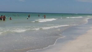 A beach with people swimming and walking along the shore. - Waterfront, Harbourside, Water Park, Beach, #3318 (Indian Rocks Beach)