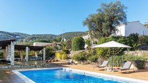 A swimming pool with lounge chairs and a covered patio area. - Wonderful private villa for 10 guests with private pool, WIFI, A/C, TV, patio and panoramic view (Calonge)