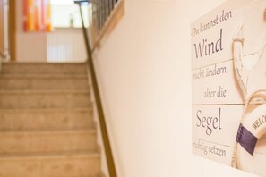 A staircase leading to a room with a sign that reads "The wind can change, but the soul remains the same."