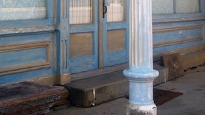 A building facade with a sign reading "Art of the Prairie Gallery" and a door with a number "5" on it. - Former Art Gallery is now spacious lodging (Sedan)