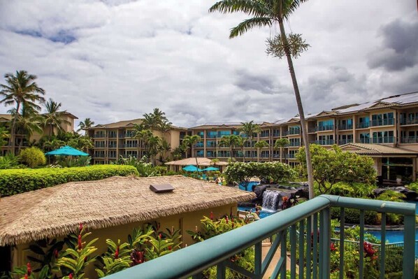 A resort with multiple buildings, a swimming pool, and lush landscaping.