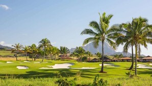 A golf course with palm trees, bunkers, and a clear sky. - 10 Bedroom Sleeps 24 w/ AC - Less than a 1 Minute Walk with views of Poipu Beach (Koloa)