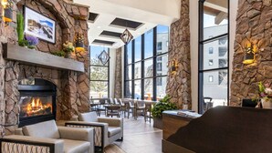 A lobby with a stone fireplace, seating area, and large windows offering views of the outside. - Labor Day Sale - Limited Time Offer, Save up to 30% (Park City)