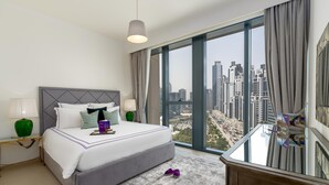 A modern hotel room with a large bed, a glass table, and a city view. - Dream Inn Apartment- Boulevard Heights (Dubai)