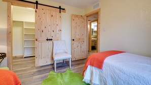 A bedroom with a bed, a chair, and a wardrobe. - Fort Worth Home w/ Patio: 5 Mi to Dtwn! (Fort Worth)