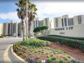 A residential building named 'PHOENIX I-IV' with a landscaped garden area in front.