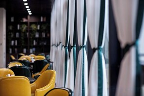 A row of yellow chairs and tables in a restaurant setting. - Puyuan X Hotel (Tongxiang)