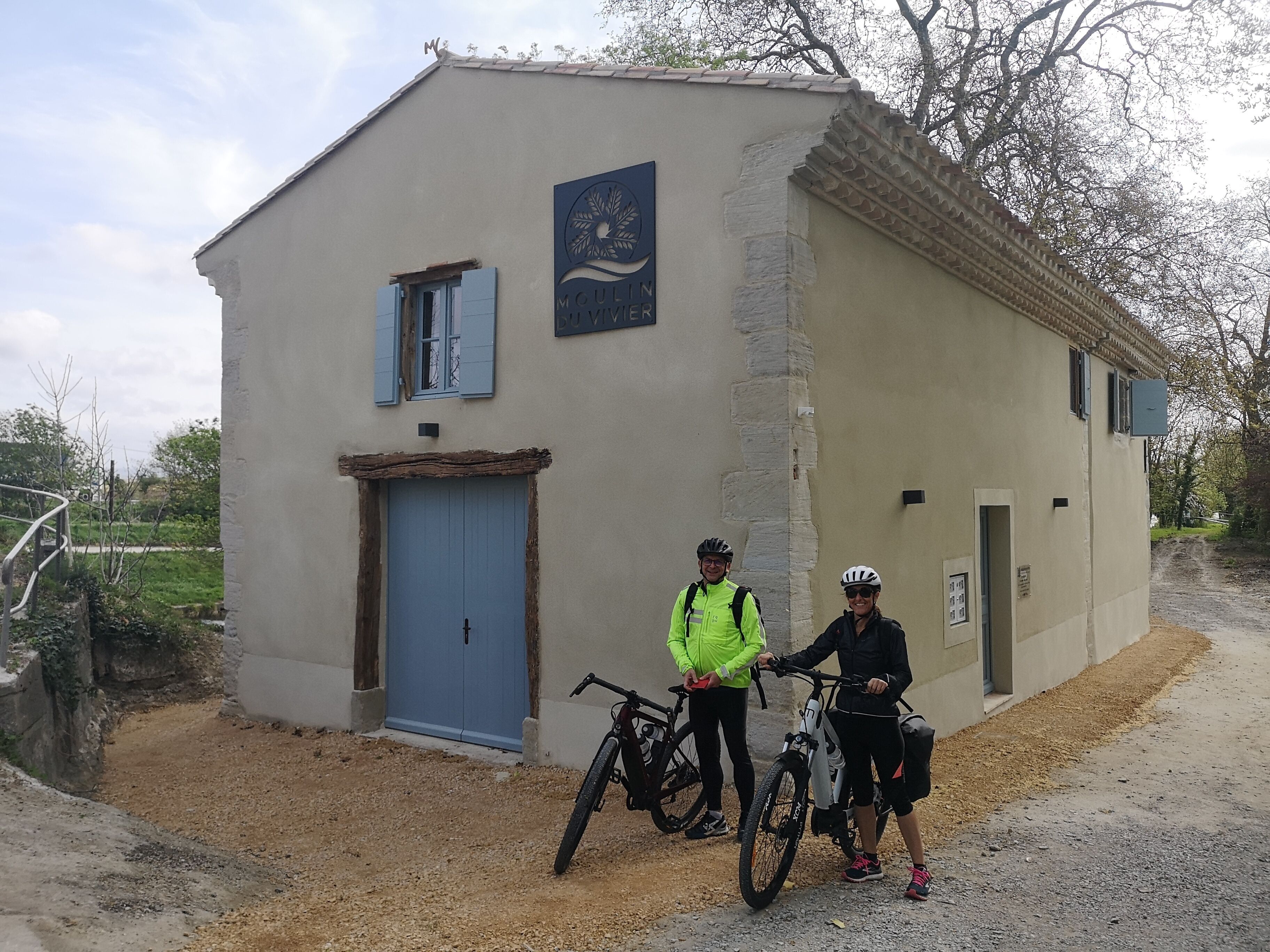 A small building with a blue door and a sign that reads "Moulin".
