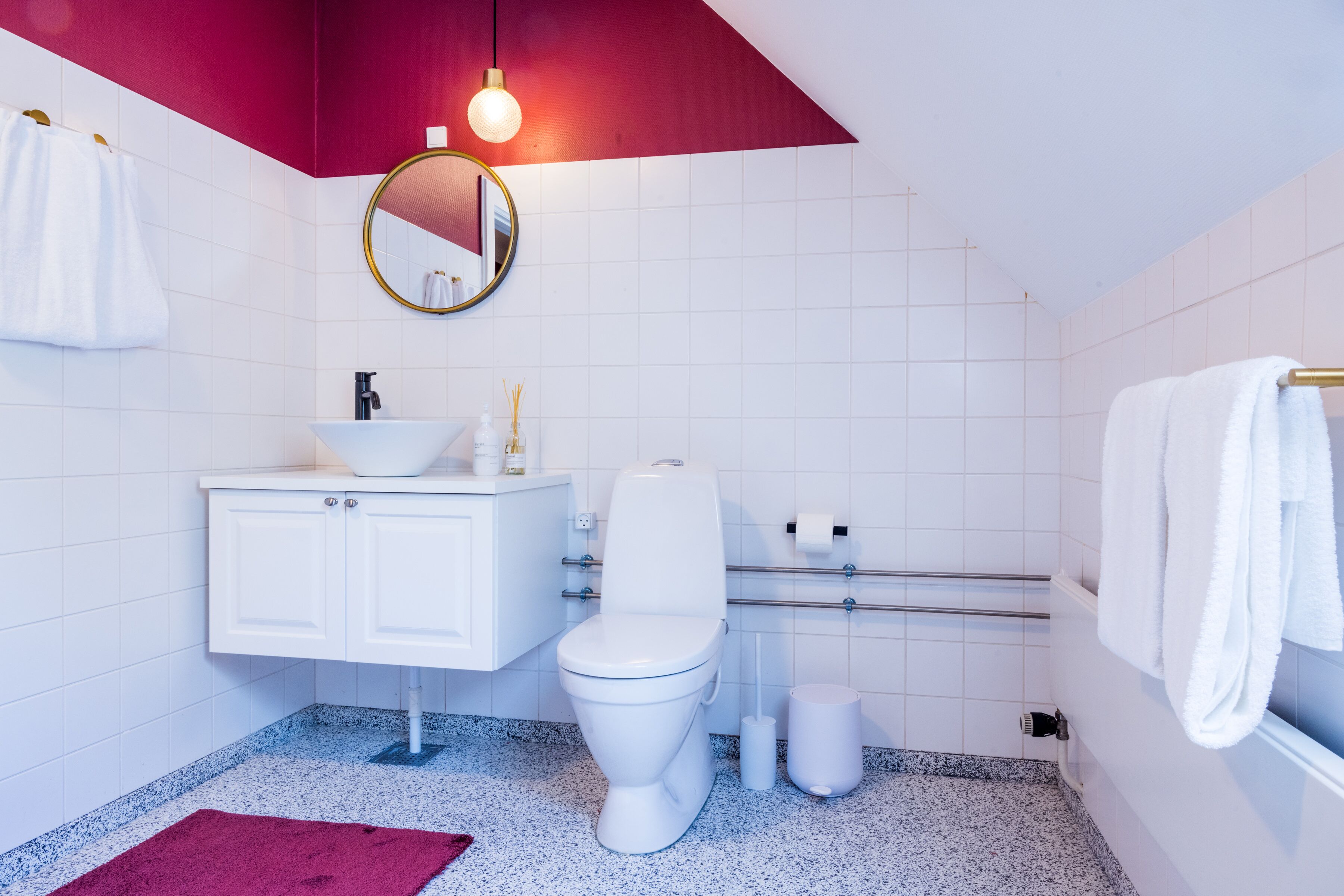 A modern bathroom with a white sink, toilet, and vanity.