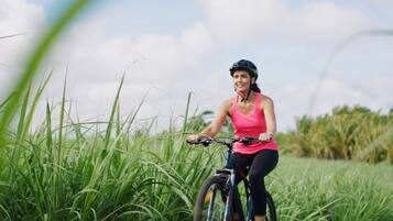 A person riding a bicycle in a grassy field.