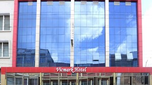 A building with a large glass facade, Vicmark Hotel signage, and a Vicmark Arcade below. - Vicmark Hotel Nakuru (Nakuru)
