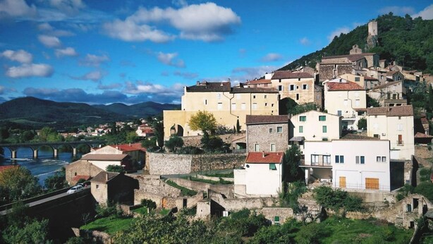 A historic town with stone buildings, a river, and a bridge. - Family winegrower's house (Roquebrun)