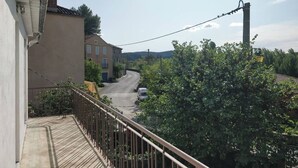 A residential street with houses, a clear sky, and a power line. - Family winegrower's house (Roquebrun)