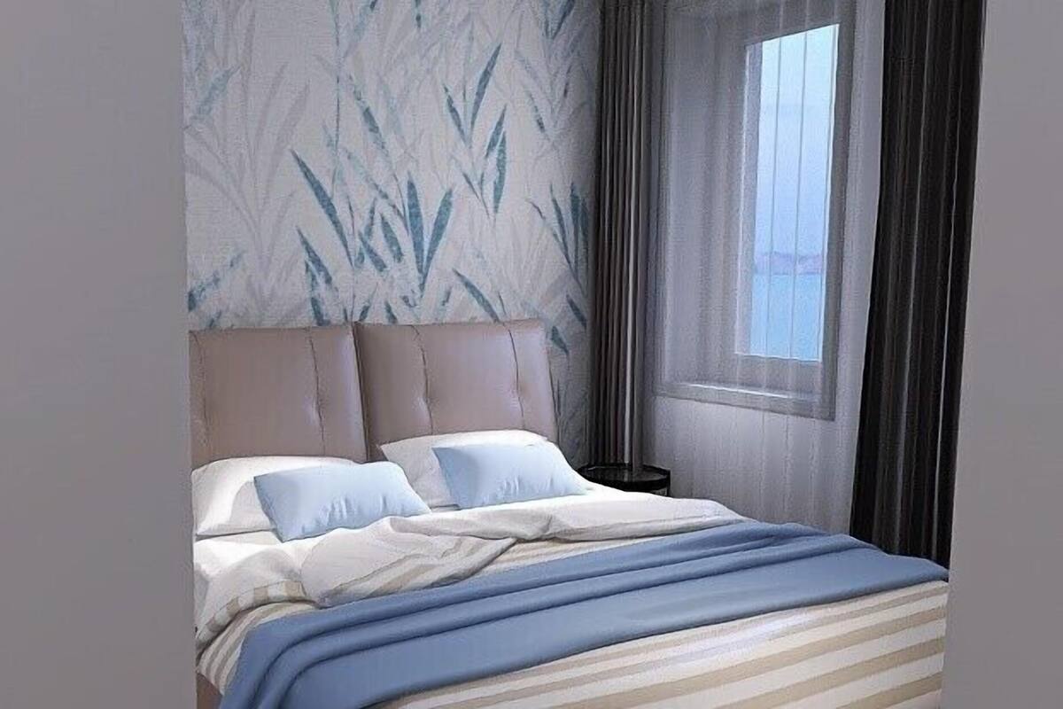 A modern bedroom with a marble-patterned headboard, a large window with curtains, and a striped bedspread.