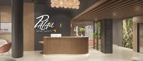 Un área de recepción moderna con un mostrador de madera, una mesa de centro de mármol y asientos contemporáneos.
