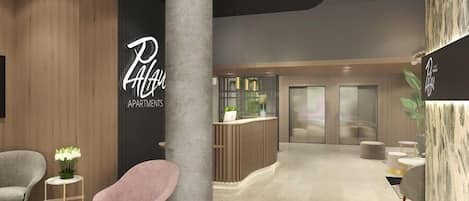 A modern lobby with a reception desk, a large pillar, and seating areas.