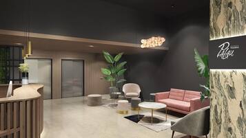 A modern lobby with a reception desk, seating area, and a large wall with a 'Palau' sign.