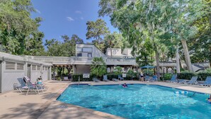 A swimming pool with lounge chairs and a lifeguard stand. - 2 BR Treetops First Floor easy to access Bikes & Beach Gear included (Hilton Head Island)