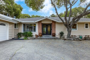 A residential house with a brick entrance, a garage, and a driveway with scattered leaves. - Deer Meadow 4BR 3Ba w Valley Views 30 Night Min (Carmel Valley)