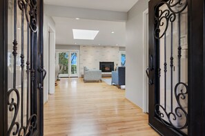A modern interior with a wooden floor, a fireplace, and a television. - Deer Meadow 4BR 3Ba w Valley Views 30 Night Min (Carmel Valley)