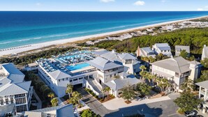 A resort with a pool area, beachfront, and multiple buildings.