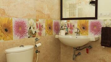 Casa de banho com sanita, lavatório e espelho.