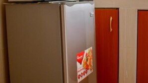 A kitchen with a refrigerator, microwave, and a stove. - Faraja Guest House (Naivasha)