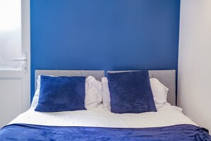 Cozy retreat with a neatly made bed and simple, clean design.
