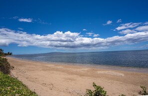 Enjoy a serene beach experience with gentle waves lapping at the shore.