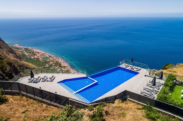 An infinity pool, pool loungers