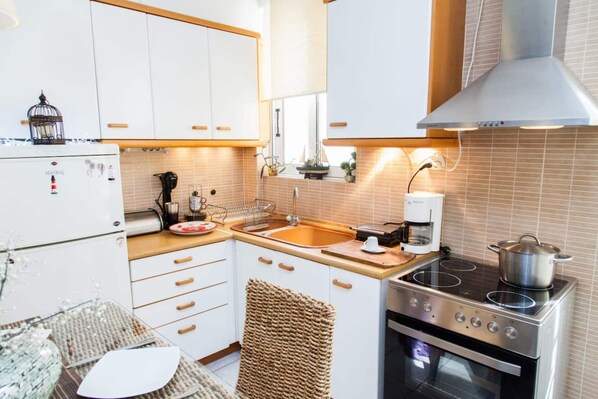 Enjoy cooking in this well-equipped kitchen with a single burner stove, sink, and coffee maker.